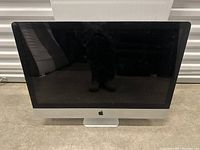 Front view of Apple iMac computer with screen turned off, showing black display and silver aluminum body.