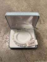 Bracelet in light blue presentation box with satin lining showing trademark Swarovski Elements tag.