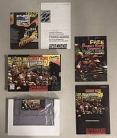 All contents laid out: game box, cartridge, instruction manual, consumer information booklet, promotional insert.