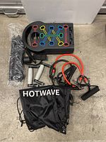 Set of Hotwave branded fitness equipment including a step platform, resistance bands, and carry bag.