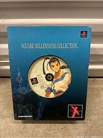 Front view of the original Square Millennium Collection Xenogears PlayStation 1 boxed game, displaying the game disc with character art visible through the box window.