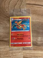 Front side of Special Delivery Charizard Pokémon promo card inside plastic sleeve, showing artwork, HP, and move details.
