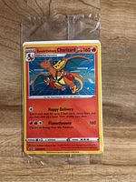 Photo of a Special Delivery Charizard Pokémon card sealed in a clear plastic sleeve on a wooden surface.