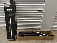 Boxed Thule Sidearm upright mounted bike carrier packaging and parts inside