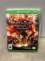 Front view of sealed Xbox One game Attack on Titan 2 Final Battle showing cover art with characters and titans in battle scene.