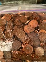 Close-up view of pennies inside plastic bag showing copper color and worn condition