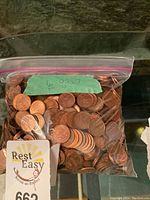 Zip-lock bag filled with Canadian pennies labeled with weight 6 lbs 5.7 oz.
