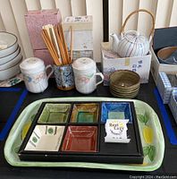 Overall view showing mugs, serving set, chopsticks, bowls, and teapot on a table