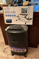 Royal 16CDX crosscut shredder and Armyte laptop stand box placed on a desk with shredder in front