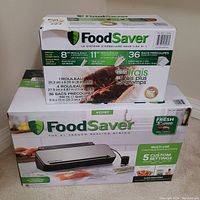 Package of FoodSaver SealFilm rolls and 36 pre-cut vacuum seal bags with product dimensions and usage details.