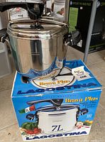 7 litre Lagostina Brava Plus stainless steel pressure cooker on top of original box showing product and branding details.
