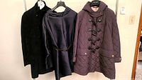 Three coats on rack: black velvet, navy Max Mara, burgundy Burberry Brit