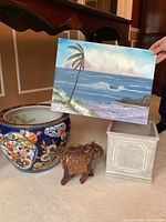 Photo showing all items in the lot: two planters, elephant figurine, and seascape painting.