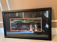 Full view of the professionally framed Indigenous art print titled "Stolen Stories" with black frame, showing northern lights background and figures in foreground.