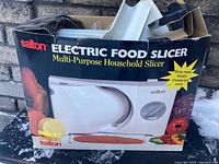 Box showing Salton Electric Food Slicer branding and image depicting the product and its uses.