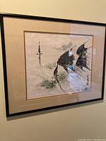 Framed original ink painting on wall showing three black fish swimming near plants. Signed by artist