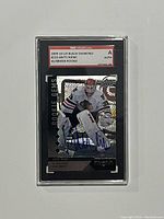 Front view of 2009-10 Upper Deck Black Diamond #210 Antti Niemi rookie card in protective case showing player image and autograph