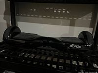 Front view of the black Gravity Blade hoverboard showing the overall shape and foot pads.