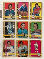 Front view of 9 vintage 1972-73 O-Pee-Chee hockey cards showing players in colorful uniforms and logos