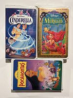 Photo showing three Disney VHS tapes in original cases: Cinderella, The Little Mermaid, and Pocahontas.
