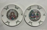 Two Royal Doulton Christmas collector plates placed side by side showing their full front designs with holly accents and embossed patterns.