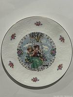 Top view of the Royal Doulton Valentine's Day 1980 collector's plate showing central illustration of two children on a swing surrounded by floral accents.