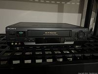 Front view of Sony SLV-N50 VCR showing tape slot, control buttons, and branding.