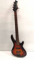Full view of the Johnson by AXL bass guitar showing its sunburst finish, full neck, body and bridge.