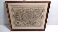 Framed whole map print showing Luxembourg and surrounding areas with a brown wooden frame and beige matting.