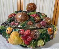 Front angle view of the large hand-painted Italian ceramic fruit bowl with a lid, showing detailed ceramic fruit decoration