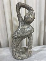 Full front view of the abstract marble figurine sculpture showing overall shape and polish.