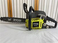 Full side view of Ryobi RY3714 chainsaw showing 14 inch cutting bar and body