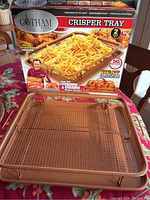 Gotham Steel crisper tray and basket displayed with original box showing product branding and features.