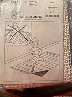 Packaging label showing brand, product name 'Stopp', materials polyester and PVC, size approx 51x71 inches, and safety usage instructions.