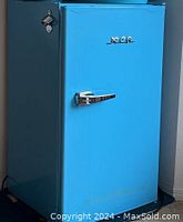 Front view of blue RCA bar refrigerator with chrome handle