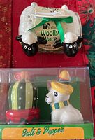 Woolly Ware Irish sheep shaped salt and pepper shakers with tag and green bow in original packaging, and Mexican themed cactus and chihuahua salt and pepper shakers in original box.