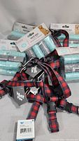 Multiple large dog collars and several packs of dog waste bags in light blue/green color.
