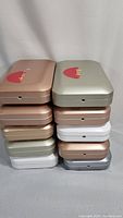 Stack of 10 PhoneSoap 3.0 UV Sanitizer units in assorted colors, closed lids
