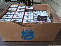 Cardboard box containing 24 sealed boxes of PlusOne wipes, showing brand and packaging details.