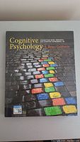 Front cover of the cognitive psychology hardcover book showing colorful bricks on a cobblestone path and title text.