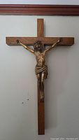 Front view of the wooden crucifix with brass Jesus figure.