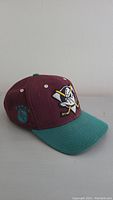 Front and left side of the Anaheim Mighty Ducks snapback hat, showing embroidered team logo and NHL logo on side.