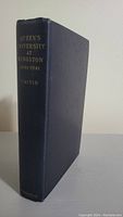 Photo of closed hardcover book with title and author on spine
