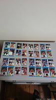 Lot of uncut hockey cards sheets containing 24 cards total, arranged on a table