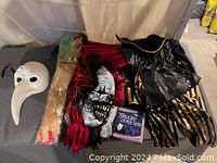 Full lot showing masks, audio book, and costumes arranged on surface