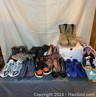 Full view of assorted shoes of different types and brands arranged on a table including boots, sneakers, heels, and casual shoes in various colors and sizes.