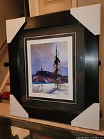 Framed fine art print by Franz Johnston with black frame and white corner protectors shown at an angle.