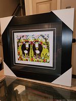 Front view of the framed Maud Lewis fine art print 'Oxen in Springtime', showing colorful depiction of two oxen with floral background, signed by the artist.