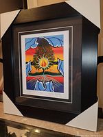 Framed fine art print in dark wood frame with double white and black mats showing full framed size and corner protectors.