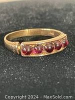 Top and side view showing garnet stones set in 10 kt yellow gold band